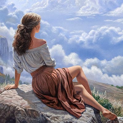 A woman in the mountains, amazed by the incredible view of clouds before her.